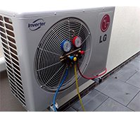 grey LG inverter with a large circlular fan shape on the left of the rectangular shaped inverter with the LG logo top left